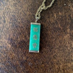 Pendent with gold Chinese lettering on green stone